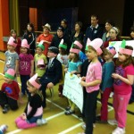 Kindergarden class wear hats to show how many pennies were raised